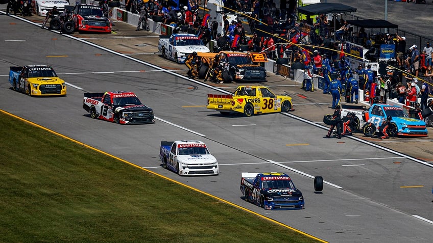 nascar crew member hit in the pits as driver spins out