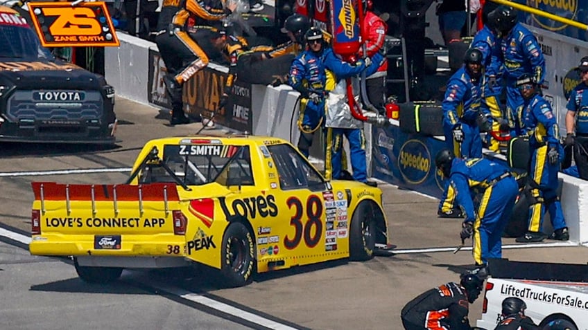 nascar crew member hit in the pits as driver spins out