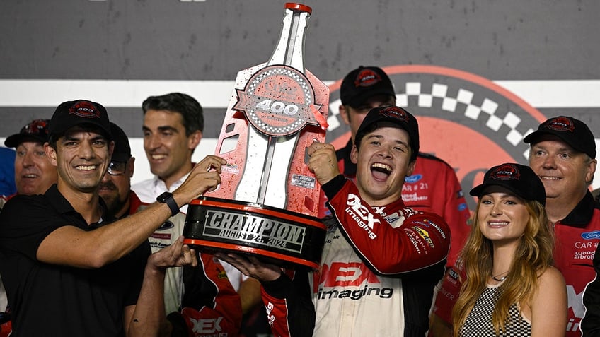 Harrison Burton holds the trophy