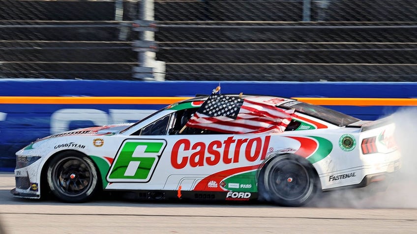 Brad Keselowski performs a victory lap