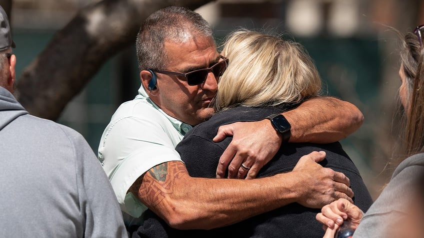 David Flagg, United Cajun Navy, left, embraces Michelle Strain Whiteid moments before a press conference to update the public about the disappearance of University of Missouri student Riley Strain