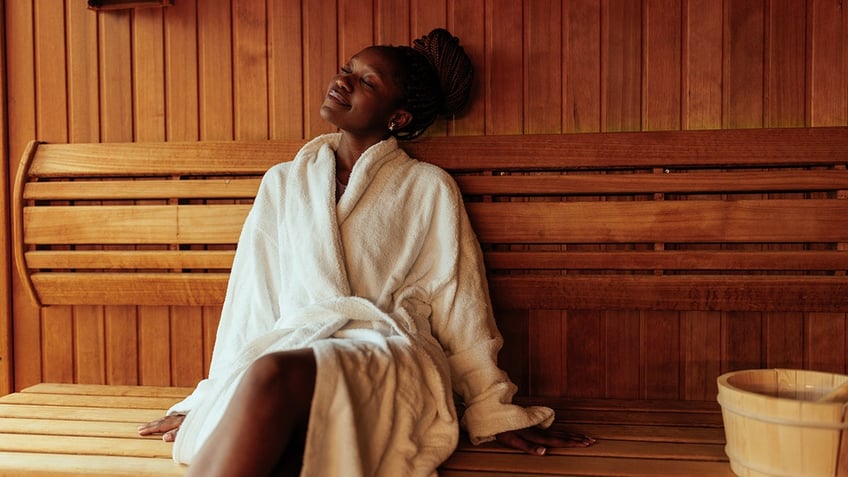 woman sits in sauna