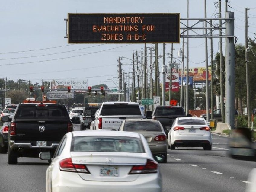 Highway signage announces the impending arrival of Hurricane Milton and the evacuations zo