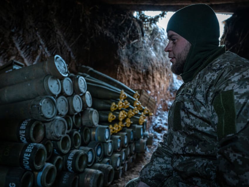 DONETSK OBLAST, UKRAINE - JANUARY 22: A Ukrainian soldier waits for orders near artillery shells for the M109 artillery self-propelled vehicle on the front line, in the direction of Bakhmut, where clashes between Russia and Ukraine continue to take place, in Donetsk Oblast, Ukraine on January 22, 2024. (Photo by …