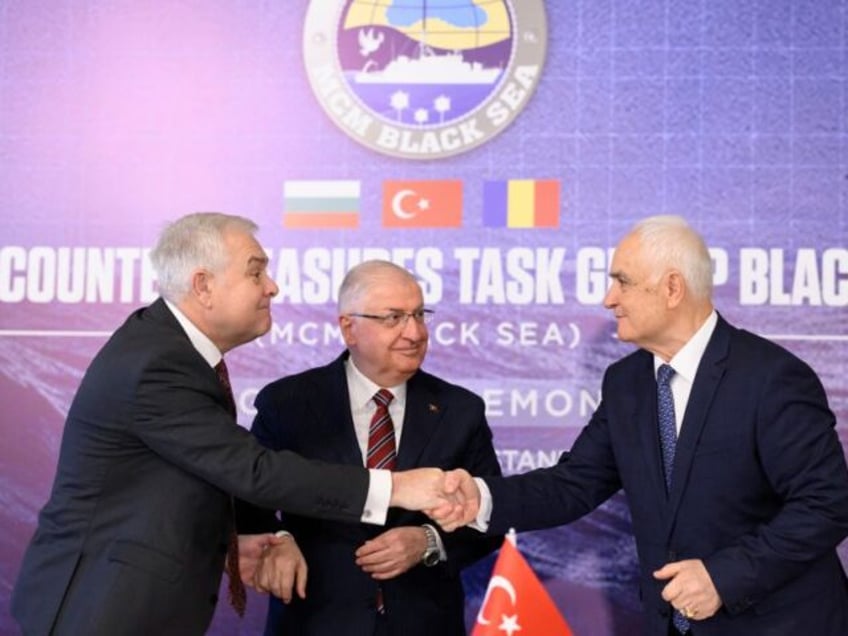 Turkish Defense Minister Yasar Guler (C), Romanian Defense Minister Angel Tilvar (L) and Bulgaria's Deputy Defense Minister Atanas Zapryanov (R) shake hands after signing an agreement on demining the Black Sea to ensure safe waters after Russia's war in Ukraine, in Istanbul, on January 11, 2024. NATO members Turkey, Bulgaria …