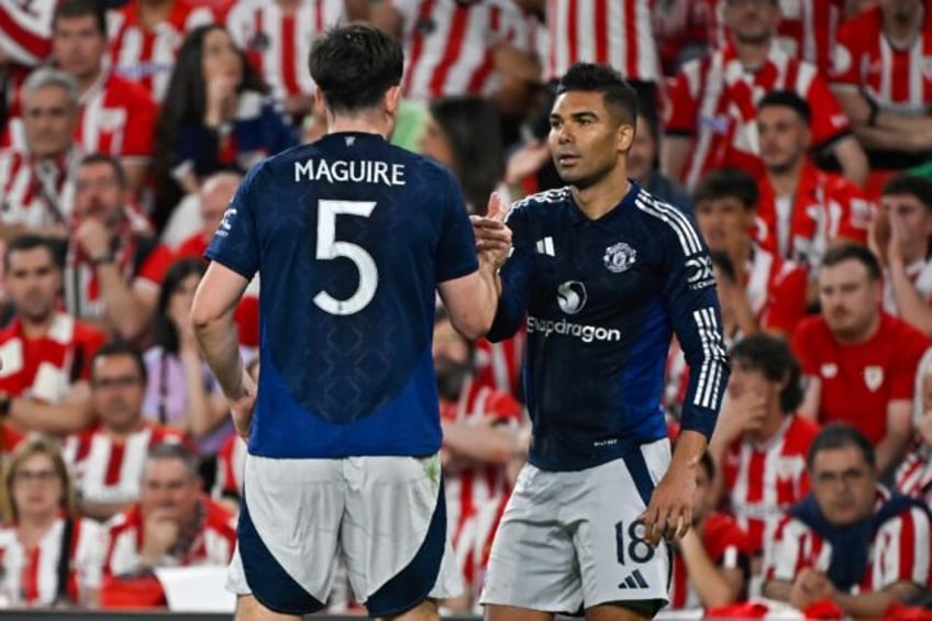 Manchester United midfielder Casemiro celebrates his goal with Harry Maguire