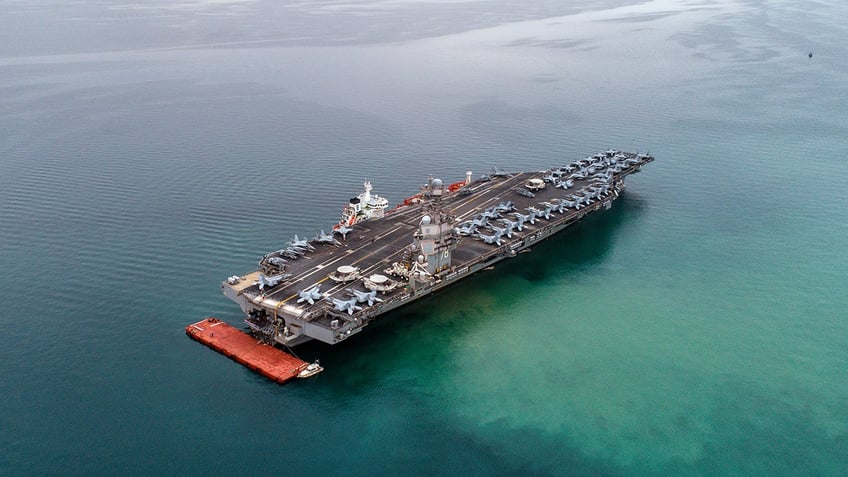 American aircraft carrier USS Gerald R. Ford is seen from the air anchored in Italy in the Gulf of Trieste. The USS Gerald R. Ford is the largest warship in the world. 