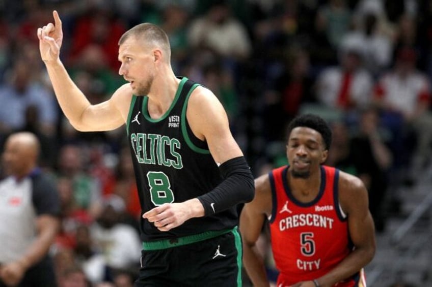 Boston's Kristaps Porzingis, front, celebrates his lone 3-point basket of the night while