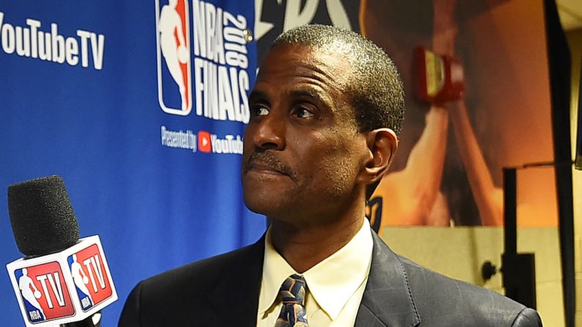 David Aldridge looks on