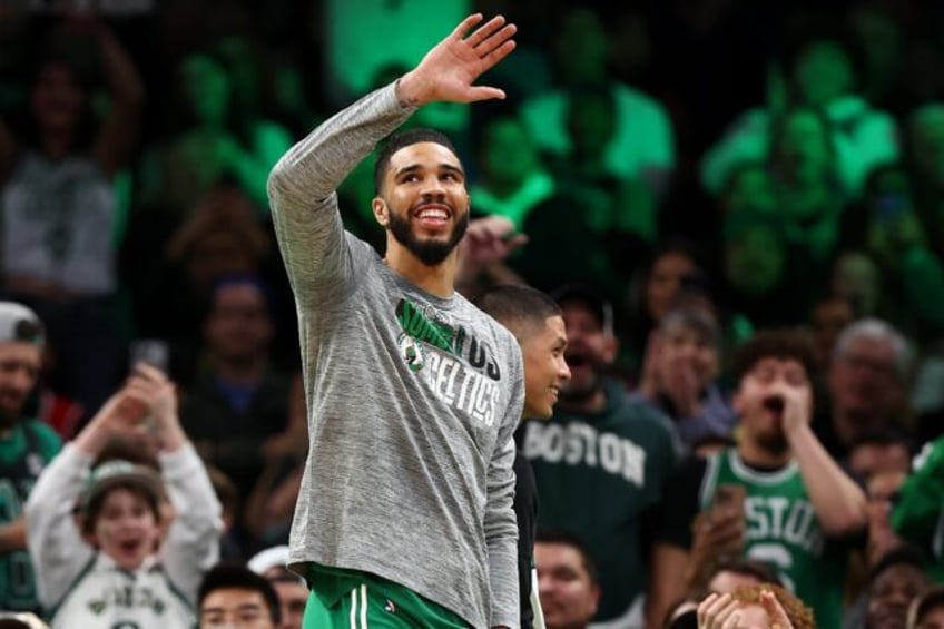 Jayson Tatum of the Boston Celtics waves to fans as they sing Happy Birthday on his 26th b