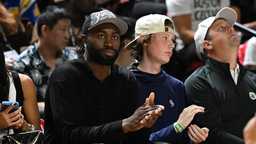 Jaylen Brown sits courtside