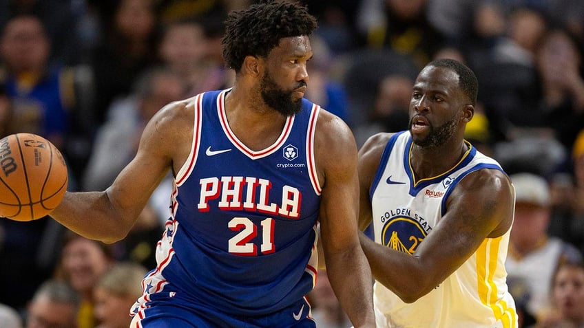 Draymond Green guards Joel Embiid