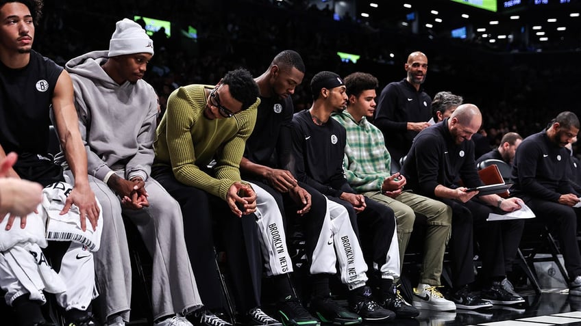 Brooklyn Nets players watch from the bench