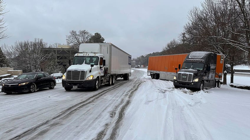 Trucks attempt to maneuver through snow and ice