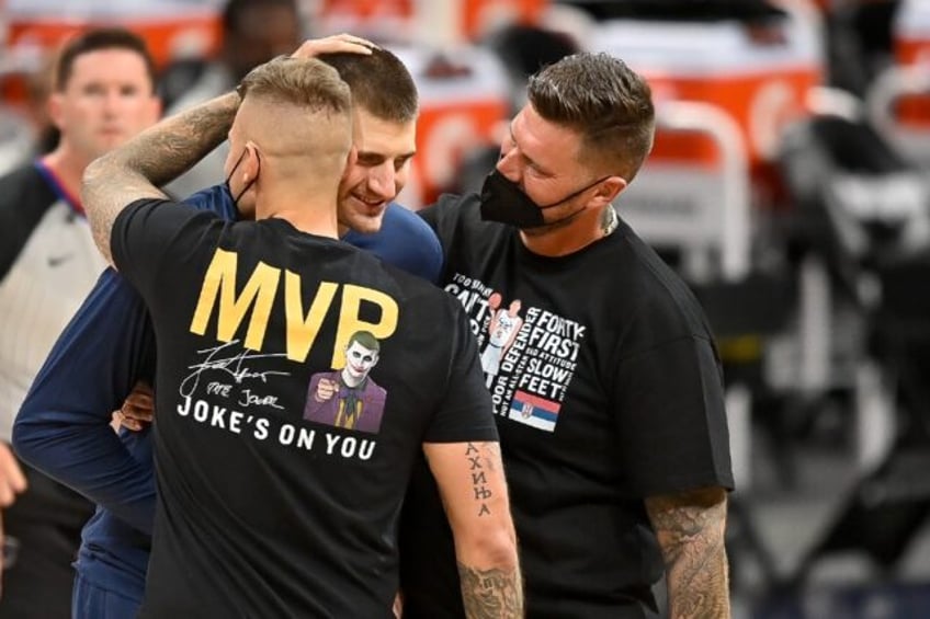 Denver Nuggets star Nikola Jokic, center, is congratulated by his brothers, one of whom is