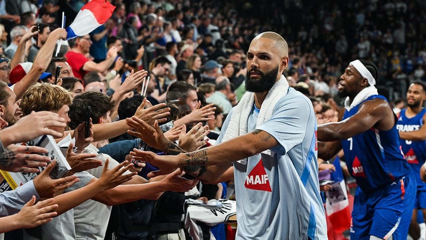 Evan Fournier high fiving fans