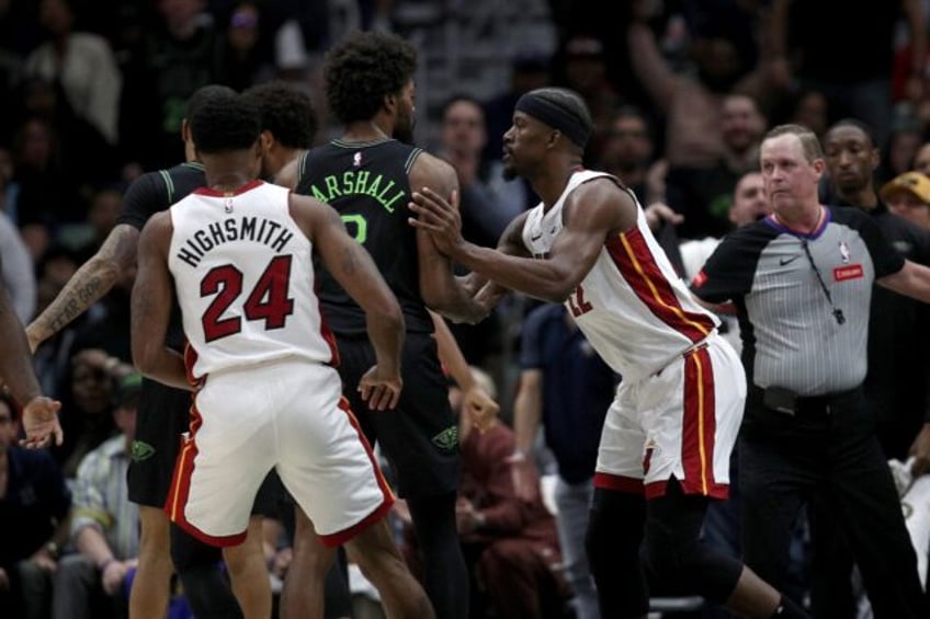 Miami's Jimmy Butler, right, pushes Naji Marshall of the New Orleans Pelicans during an al