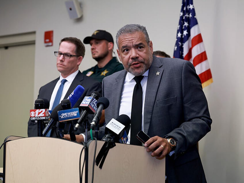 Jeffrey Veltri (L), special agent in charge of the Miami Field Office of the FBI listens a