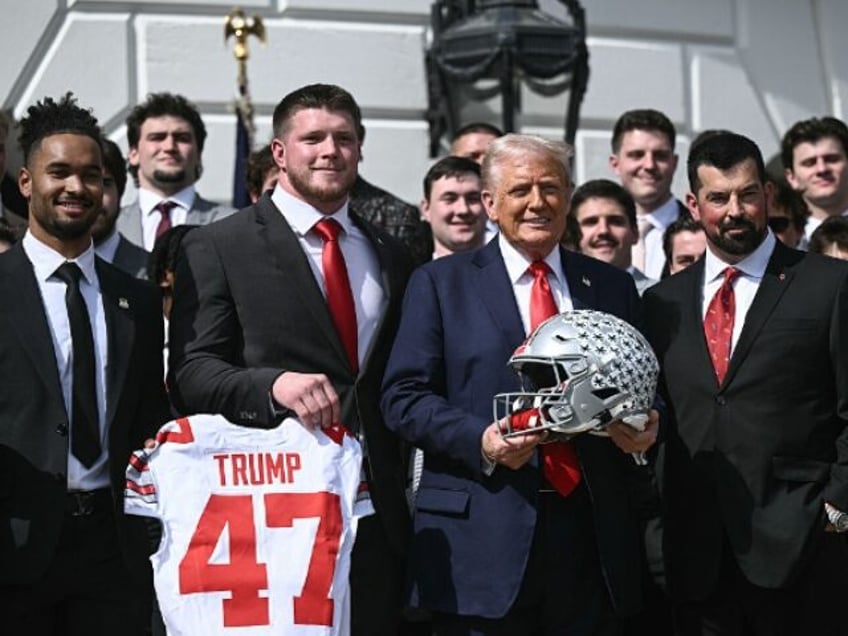 US President Donald Trump, alongside defensive end Jack Sawyer (2nd L), wide receiever Eme