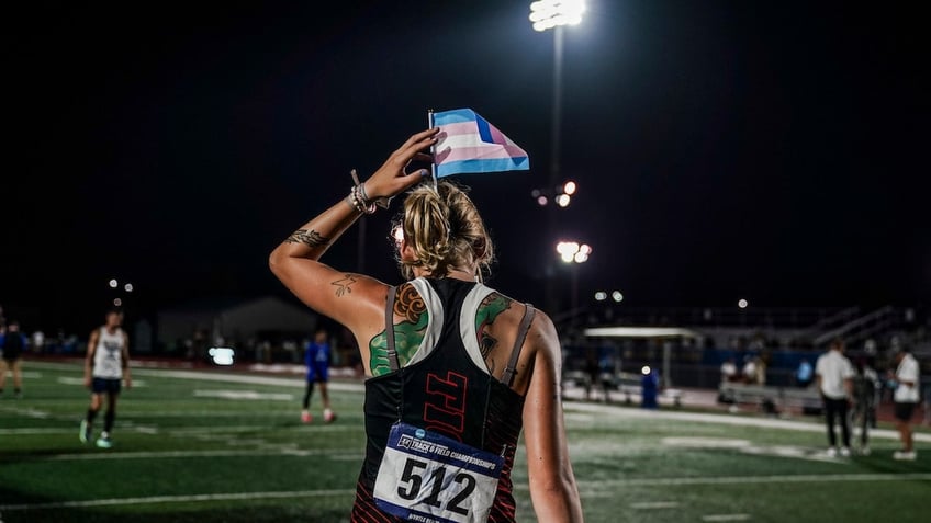 Sadie Schreiner with a trans flag