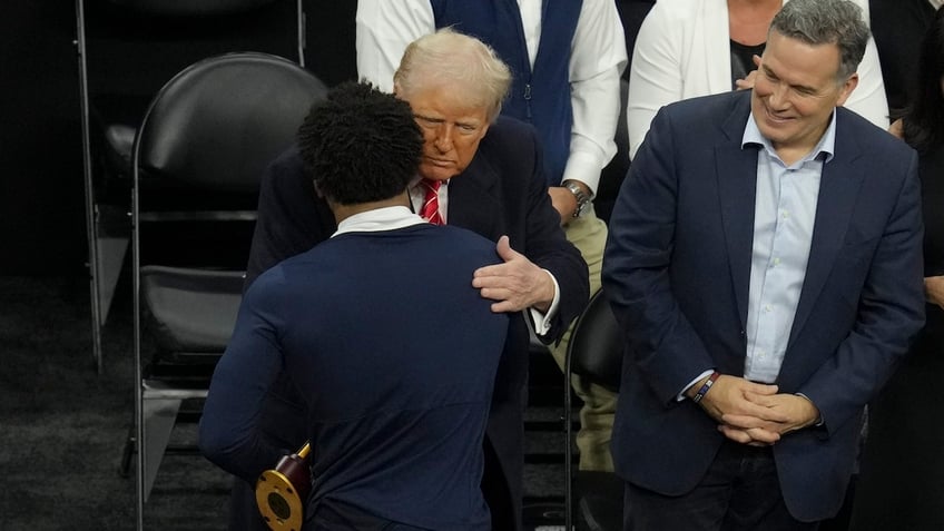 Trump hugs wrestler