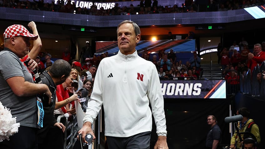 John Cook enters teh volleyball court