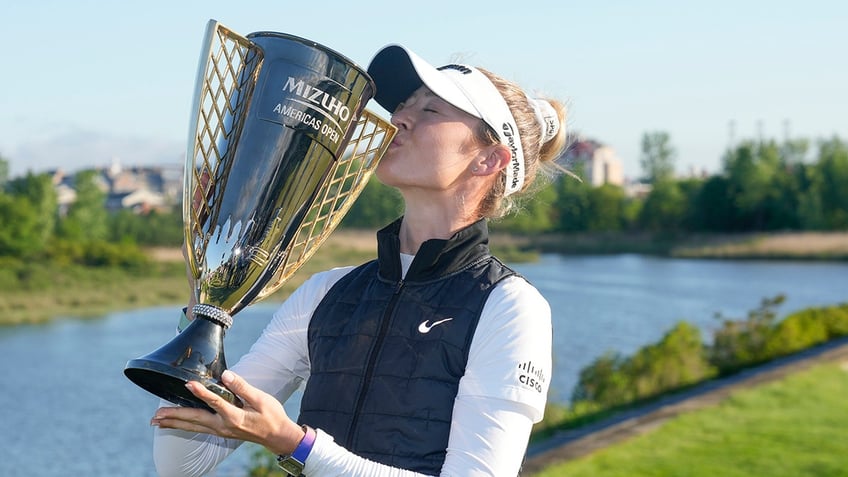 Nelly Korda poses with a trophy