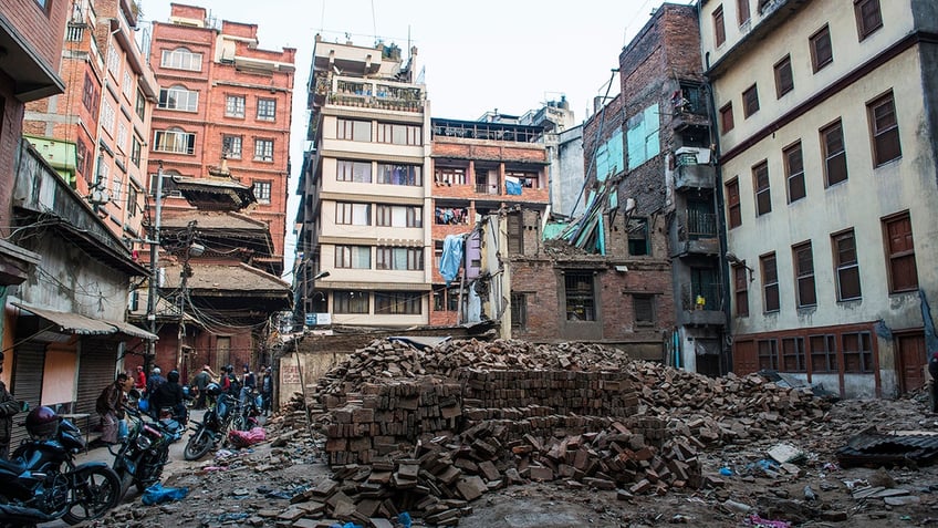 nepal earthquake left at least 128 dead dozens injured prompting massive search and rescue effort