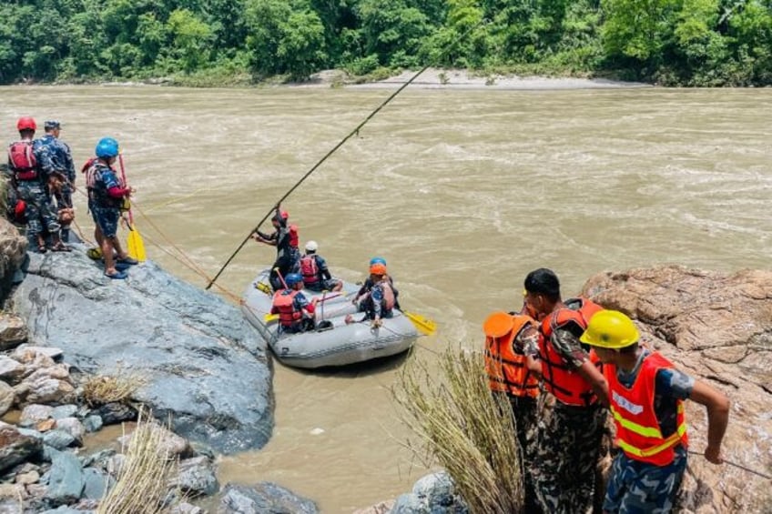 Dozens of rescuers have spent hours struggling to comb the raging Trishuli river with raft