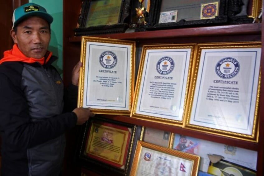 Nepali mountaineer Kami Rita Sherpa, pictured here in 2021, posing with his Guinness World