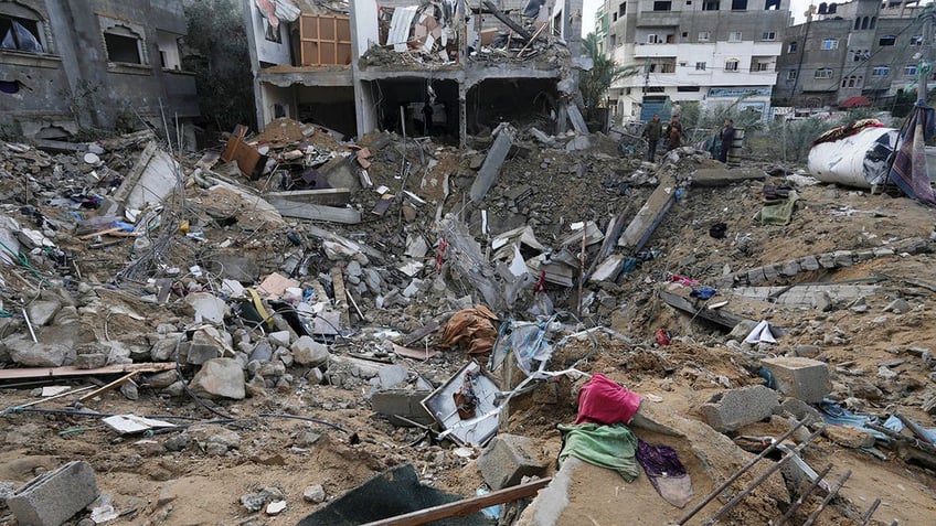 Palestinians look at destruction