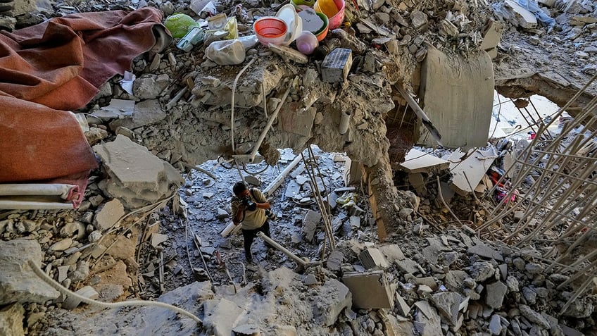 A photographer documents damage in a building that was hit by an Israeli airstrike in Beirut's southern suburb, Lebanon