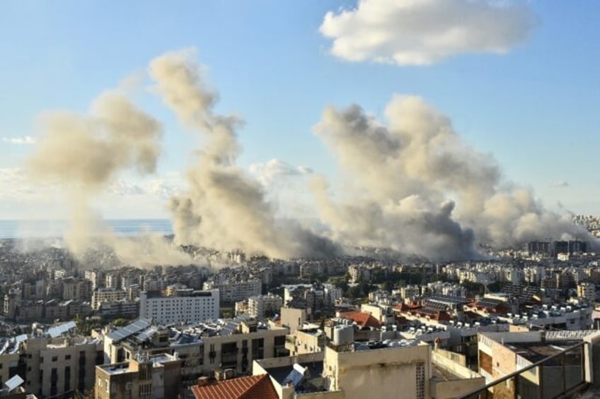 Smoke billows above Beirut's southern suburbs during a spate of Israeli air strikes on Tue