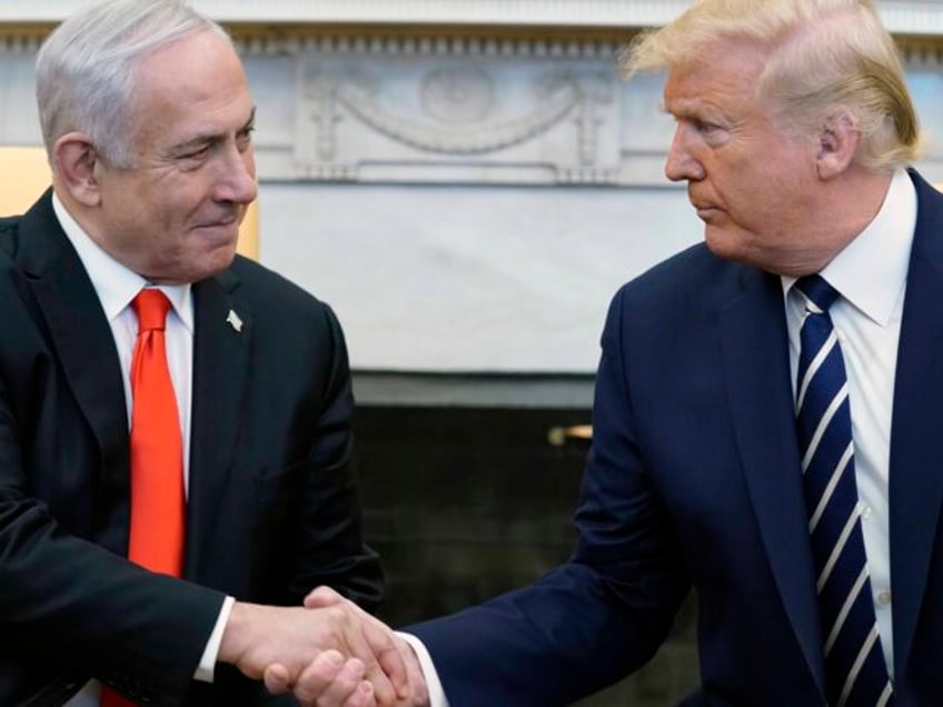 President Donald Trump, right, and Israeli Prime Minister Benjamin Netanyahu shake hands i