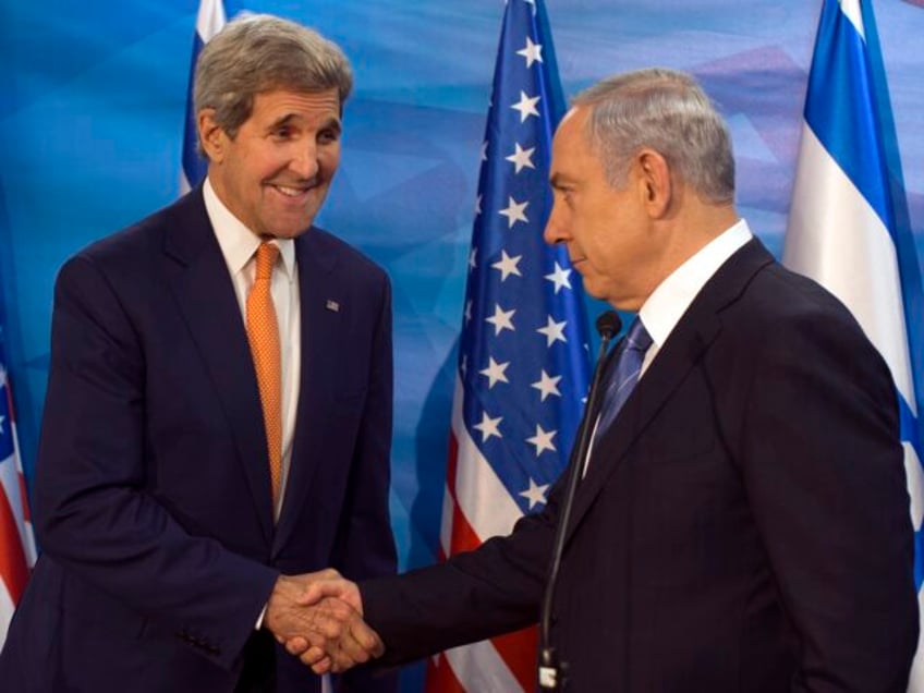 Israel's Prime Minister Benjamin Netanyahu, right, shakes hands with US Secretary of