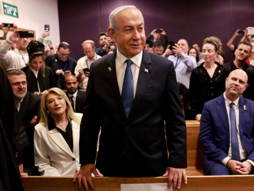 Israeli Prime Minister Benjamin Netanyahu, center, arrives to attend a hearing at the dist