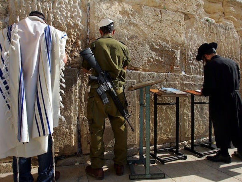 A recently drafted Israeli soldier (C), a modern Orthodox Jew (L) and a traditional ultra-