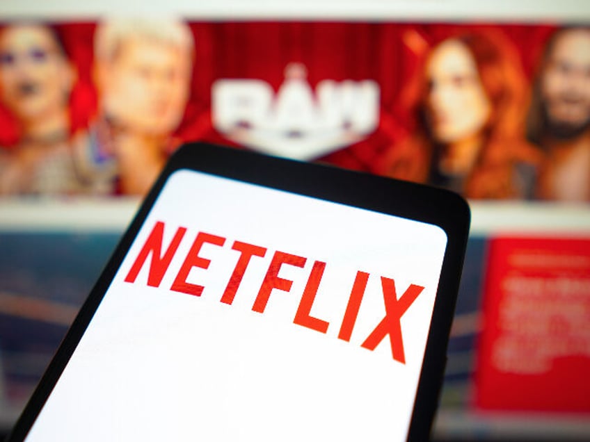 BRAZIL - 2024/01/23: In this photo illustration, the Netflix logo is displayed on a smartphone screen and WWE Raw logo in the background. Starting January 2025, Netflix will exclusively host Raw in the United States, Canada, the United Kingdom, and Latin America. (Photo Illustration by Rafael Henrique/SOPA Images/LightRocket via Getty …