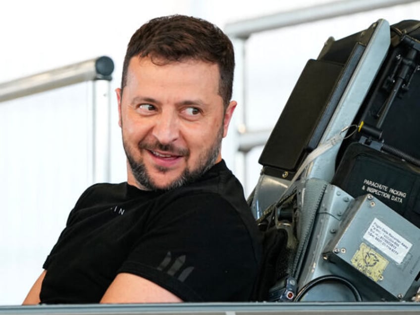 Ukrainian President Volodymyr Zelensky reacts as he sits in a F-16 fighter jet in the hangar of the Skrydstrup Airbase in Vojens, northern Denmark, on August 20, 2023. Washington has told Denmark and the Netherlands that they will be permitted to hand over their F-16 fighter jets to Ukraine when …