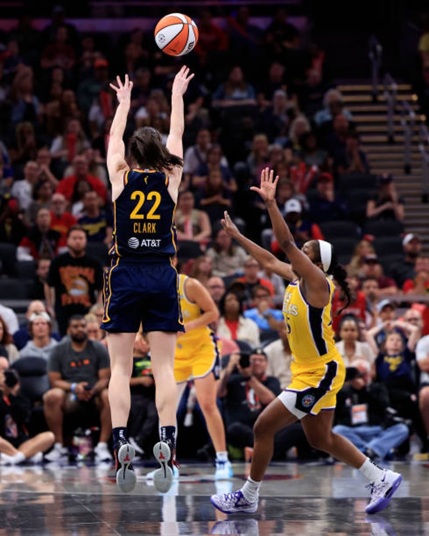 Caitlin Clark of the Indiana Fever takes a shot over Aari McDonald of the Los Angeles Sparks at Gainbridge Fieldhouse on May 28, 2024 in...