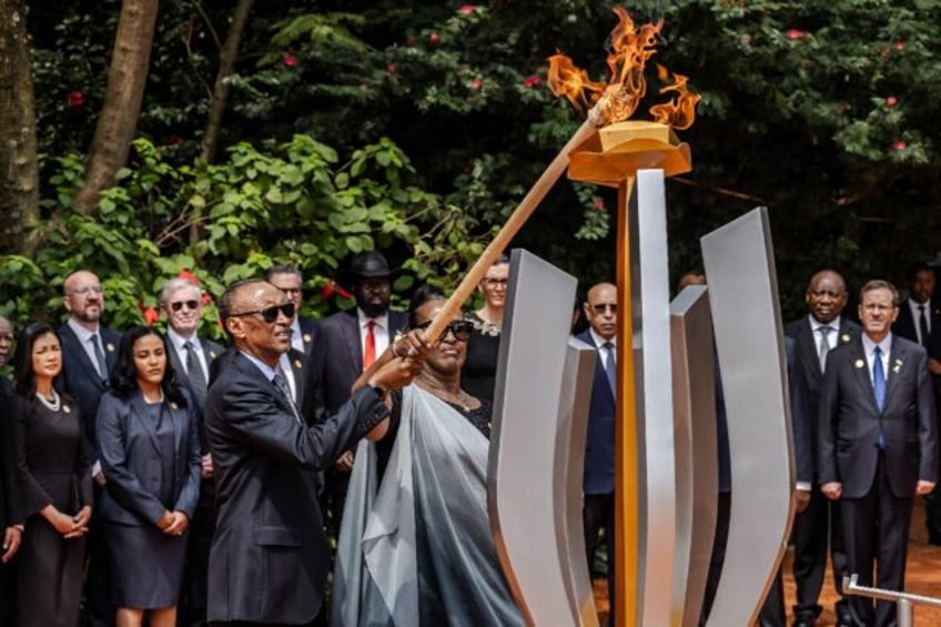 Rwandan President Paul Kagame lights a remembrance flame on the 30th anniversary of the ge