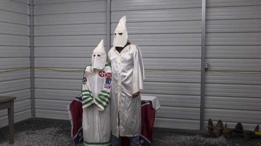 A female and male member of the Virgil Griffin White Knights, a group that claims affiliation with the Ku Klux Klan, pose for a photograph in their robes ahead of a cross lighting ceremony at a private farm house in Carter County, Tennessee July 4, 2015. The Ku Klux Klan, which had about 6 million members in the 1920s, now has some 2,000 to 3,000 members nationally in about 72 chapters, or klaverns, according to the Southern Poverty Law Center, an organization that monitors extremist groups. REUTERS/Johnny MilanoPICTURE 29 OF 34 FOR WIDER IMAGE STORY "INSIDE THE KU KLUX KLAN"SEARCH "MILANO KKK" FOR ALL PICTURES - RTX1KJWX