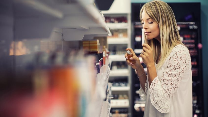 woman testing perfume in retail shop