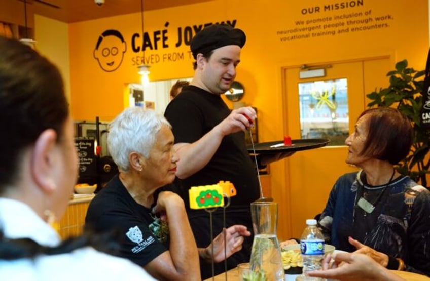 In the beating heart of New York business, Cafe Joyeux, an "inclusive" French chain of res