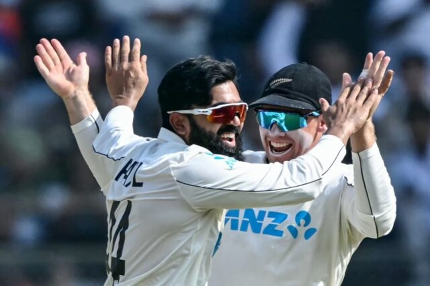 New Zealand's Ajaz Patel (left) celebrates with captain Tom Latham suring the third Test w