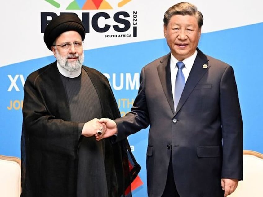 Chinese President Xi Jinping meets with Iranian President Ebrahim Raisi on the sidelines of the 15th BRICS Summit in Johannesburg, South Africa, Aug. 24, 2023. (Photo by Xie Huanchi/Xinhua via Getty Images)