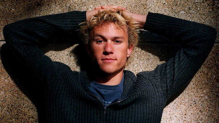 Heath Ledger puts his hand on his head