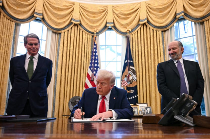 US President Donald Trump, alongside Secretary of Treasury Scott Bessent (L) and Secretary