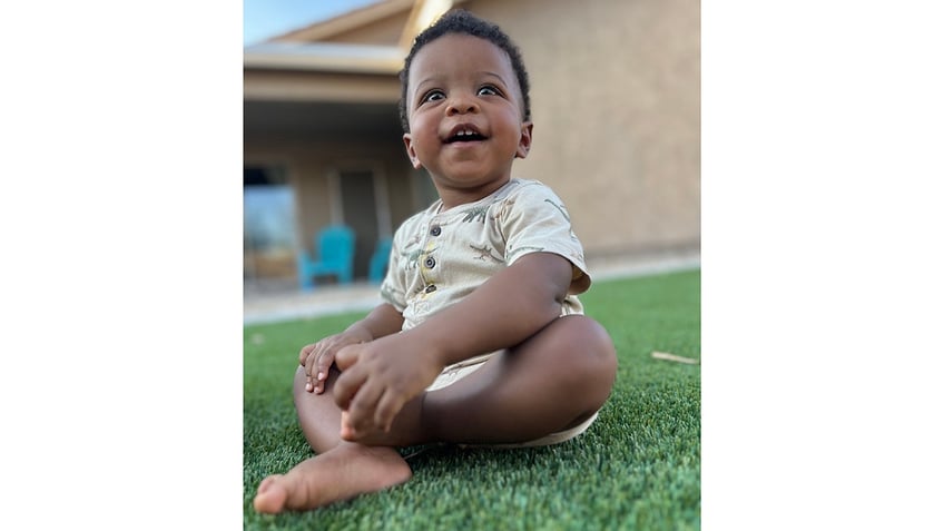 sonny gerber baby sitting on grass