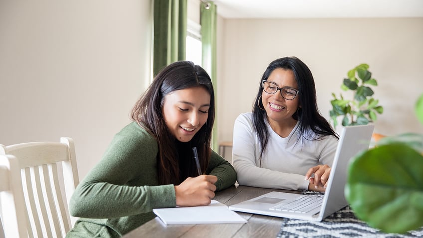 Mother and daughter working on schoolwork